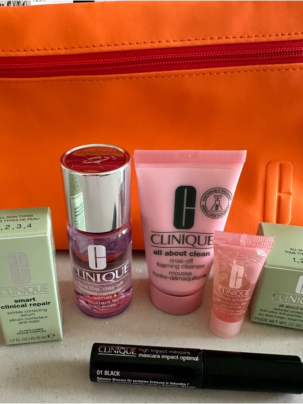 Clinique foaming leanser, wrinkle correcting serum & mascara with orange pouch
